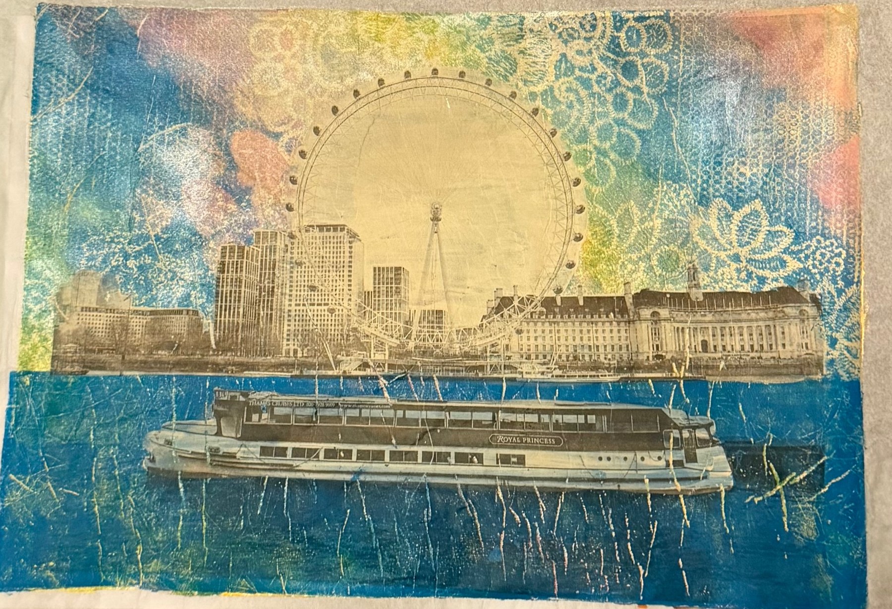 Monoprint of the London Eye and a river boat over blue and lace-patterned colour