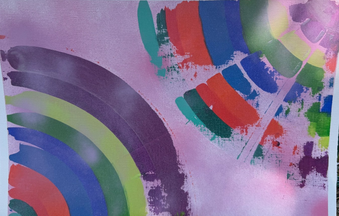 Abstract painting of rainbow arcs in red, blue, green and purple on soft pink mist
