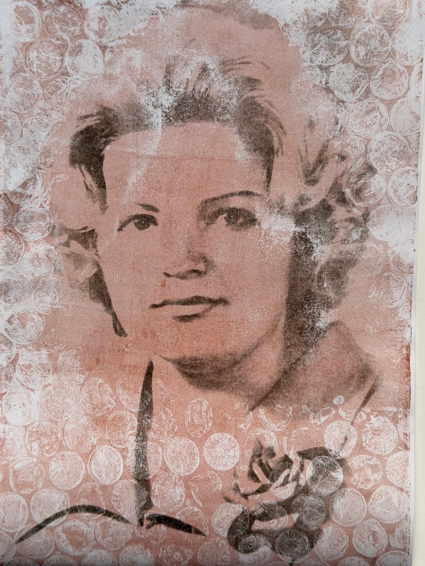 Monoprint portrait of a woman against a lace-patterned pink ground